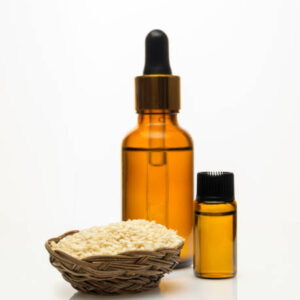 Sesame oil with sesame seeds on white background