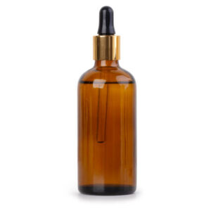 Glass bottle of oil isolated on white background