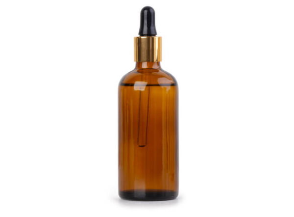 Glass bottle of oil isolated on white background